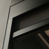 Motorised side screen in black fully deployed on a pergola, sealing the side opening