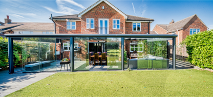 Frameless glass sliding panels on a veranda in anthracite from inside looking out