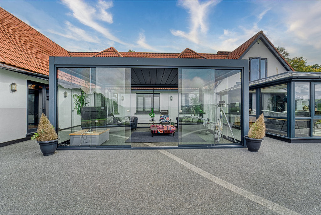 Roma Primo glass sliding panels in anthracite on a wide-span veranda enclosure