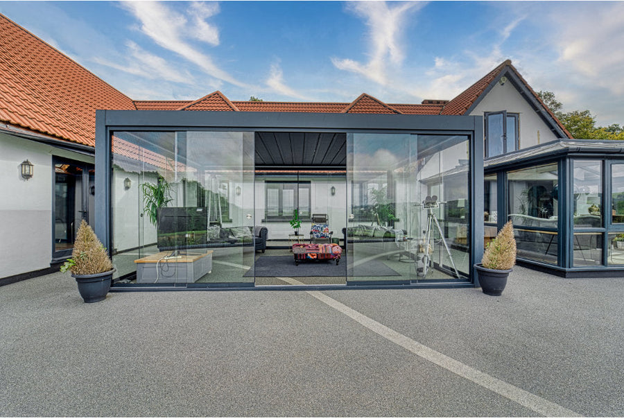 Roma Primo glass sliding panels in anthracite on a wide-span veranda enclosure