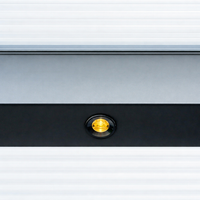 Outdoor LED spotlight in black flush-mounted in a veranda beam, lit at dusk