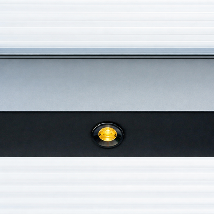 Outdoor LED spotlight in black flush-mounted in a veranda beam, lit at dusk