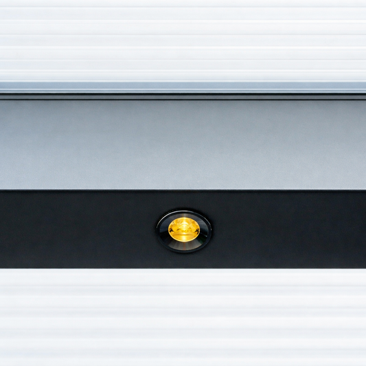 Outdoor LED spotlight in black flush-mounted in a veranda beam, lit at dusk