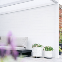 Roma Pannello panels in anthracite as a raised planter surrounding a terrace garden bed