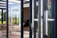 Roma Vista glass doors in anthracite on a wide veranda, panels stacked to master door