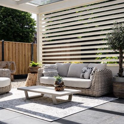 Fixed louvre side panel in white on a veranda, light filtering through angled slats