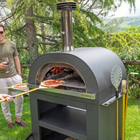 clementi gold wood gas fired pizza oven lifestyle exterior view — view 2