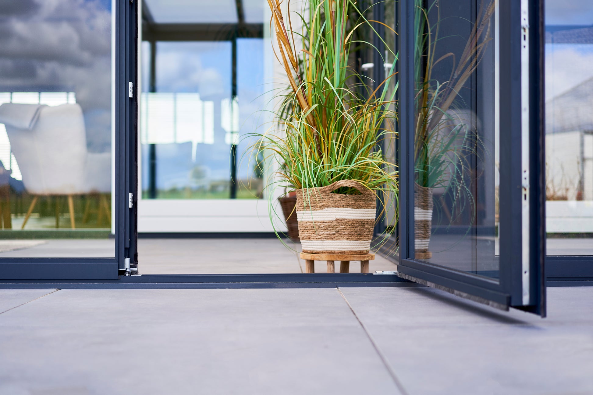 Roma Vista glass door system in anthracite showing full-width opening from inside