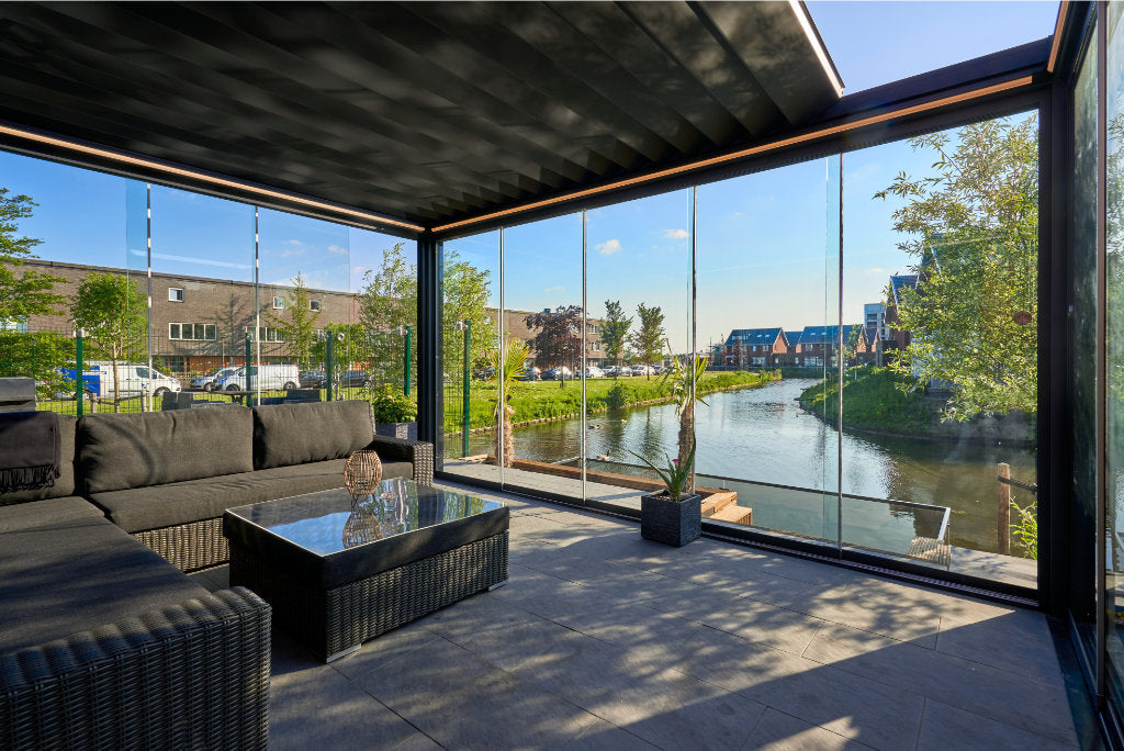 Frameless glass sliding doors in anthracite on a veranda pergola enclosure