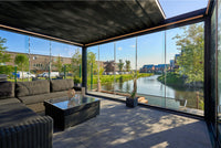 Frameless glass sliding doors in anthracite on a veranda pergola enclosure