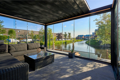 Frameless glass sliding doors in anthracite on a veranda pergola enclosure