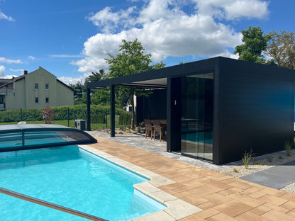 Pinela Deluxe Plus pergola in anthracite wall-mounted, panels partially retracted overhead