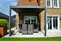 Portico pergola in white from garden with louvres angled to filter afternoon sun