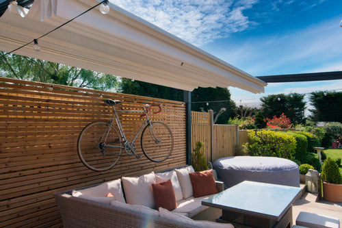 Aluminium Folding Roof Veranda | The Libero | Retractable Waterproof Fabric Roof | Integrated LED | Concealed Drainage Through Posts