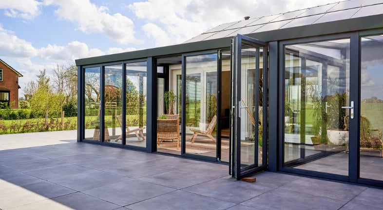 Slide and turn glass door system installed on a veranda, full-width opening achieved
