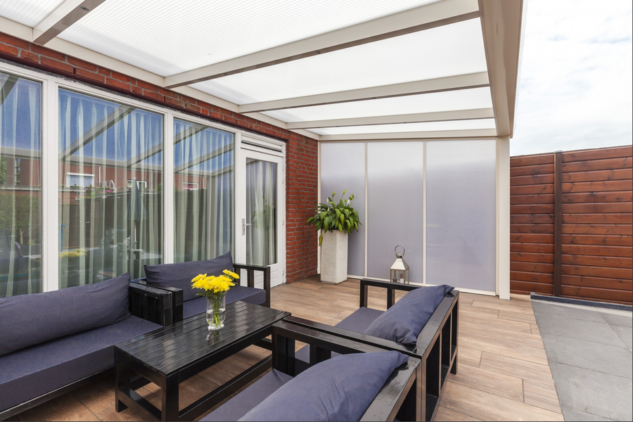 Opal polycarbonate side wall in anthracite frame installed on a rear terrace veranda