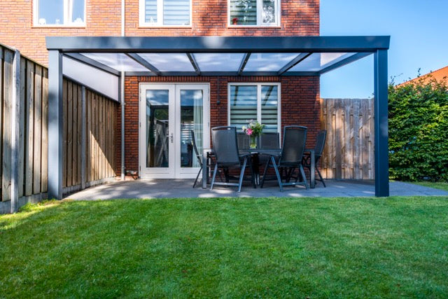 Luxa veranda in anthracite at golden hour from rear garden perspective