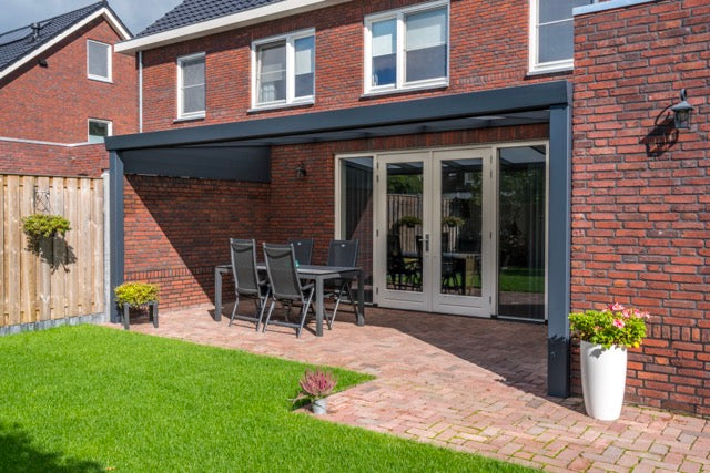 The Luxa veranda in anthracite on a home with large bi-fold doors behind