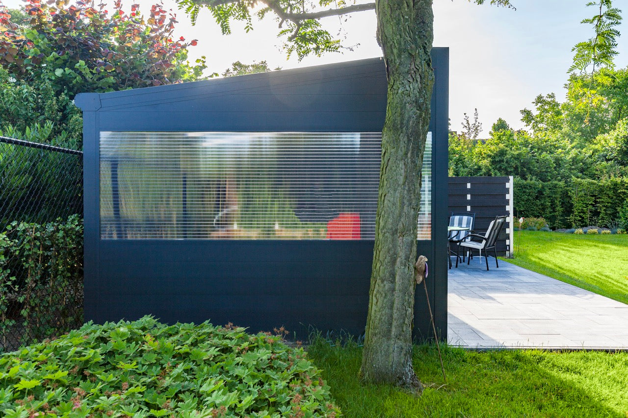 Freestanding Cascina veranda in anthracite in a mature garden setting