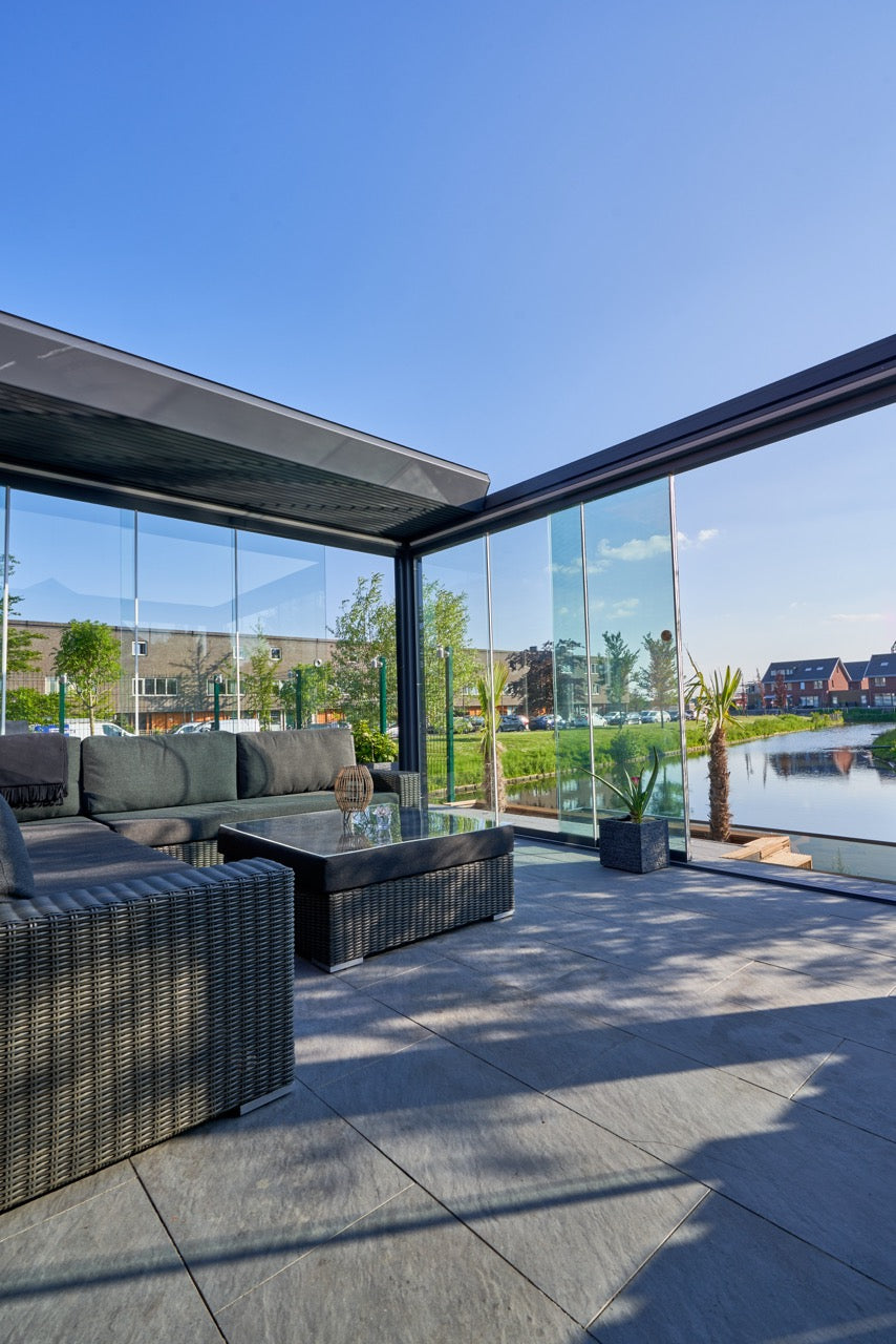 The Aperto pergola in anthracite from inside looking up through open retractable panels