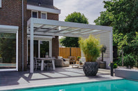 The Cristallo pergola in black spanning a rear garden terrace on a modern home