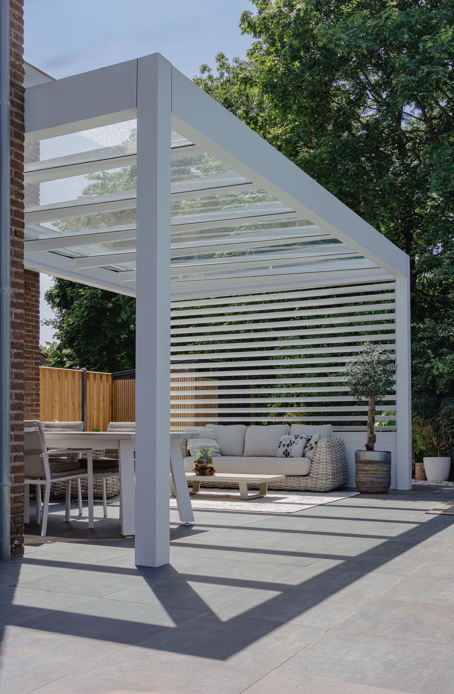 Cristallo pergola in anthracite from garden showing full span on two posts