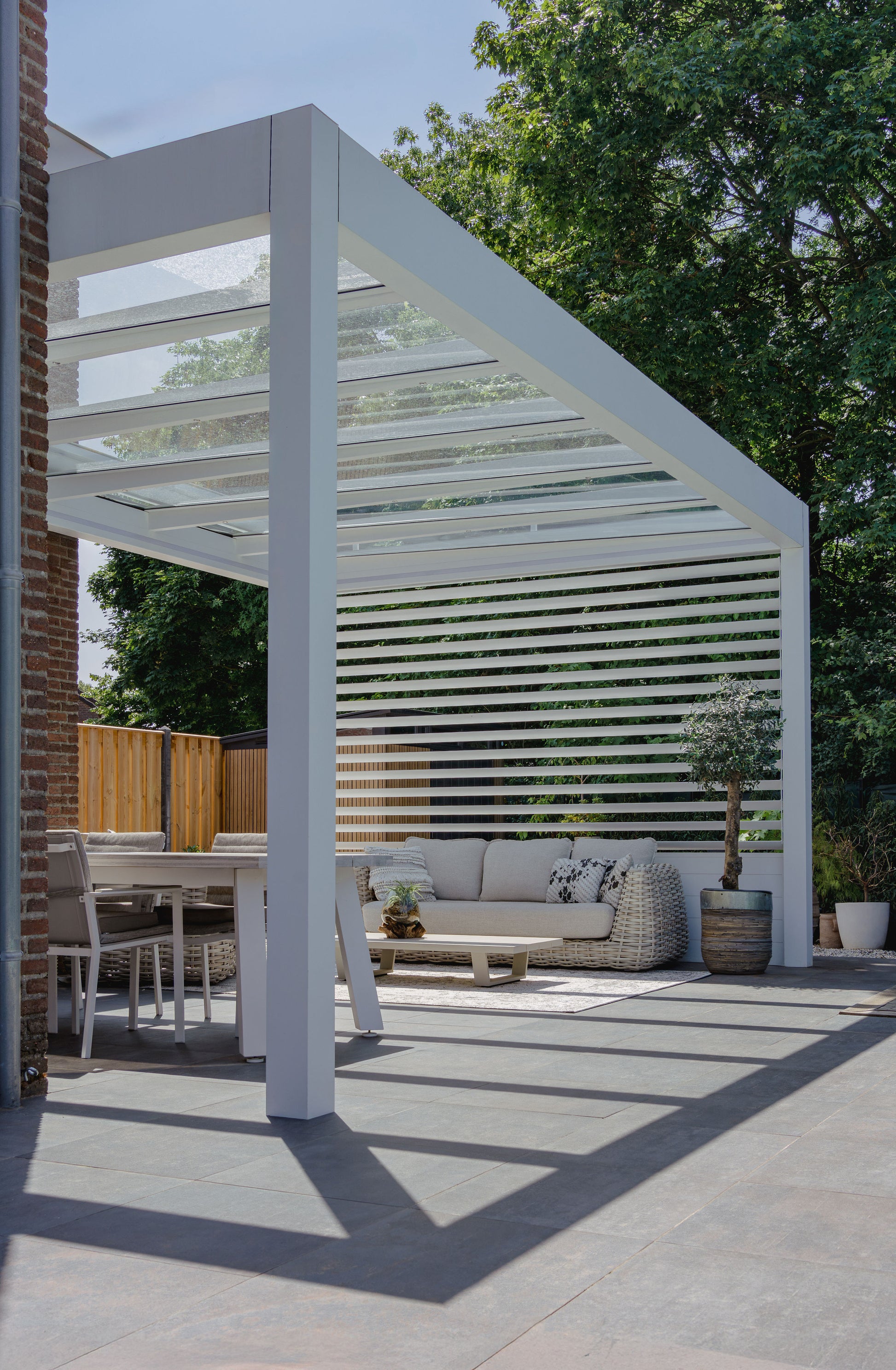 Cristallo pergola in anthracite from garden showing full span on two posts