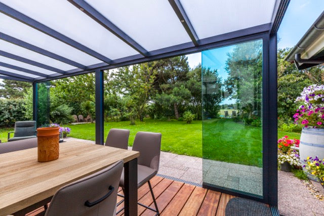 Cascina freestanding veranda in anthracite at dusk with LED lighting active