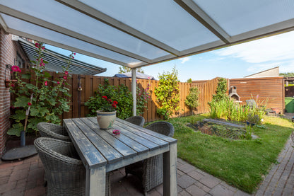 Cascina veranda in anthracite with outdoor lounge furniture positioned underneath
