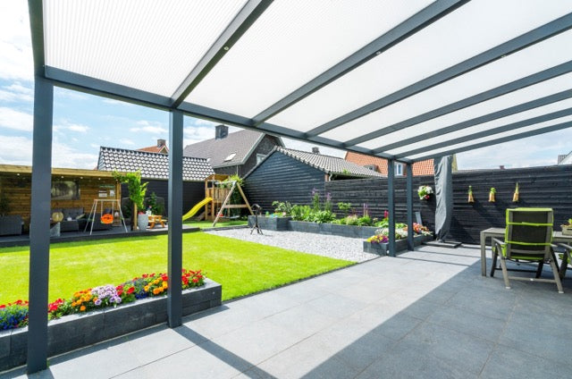 Cascina veranda in anthracite from garden perspective at golden hour
