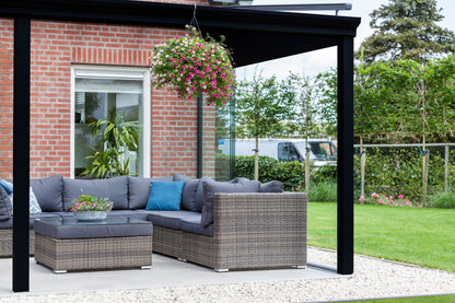 The Nobile veranda in anthracite at mid-morning, garden furniture arranged below