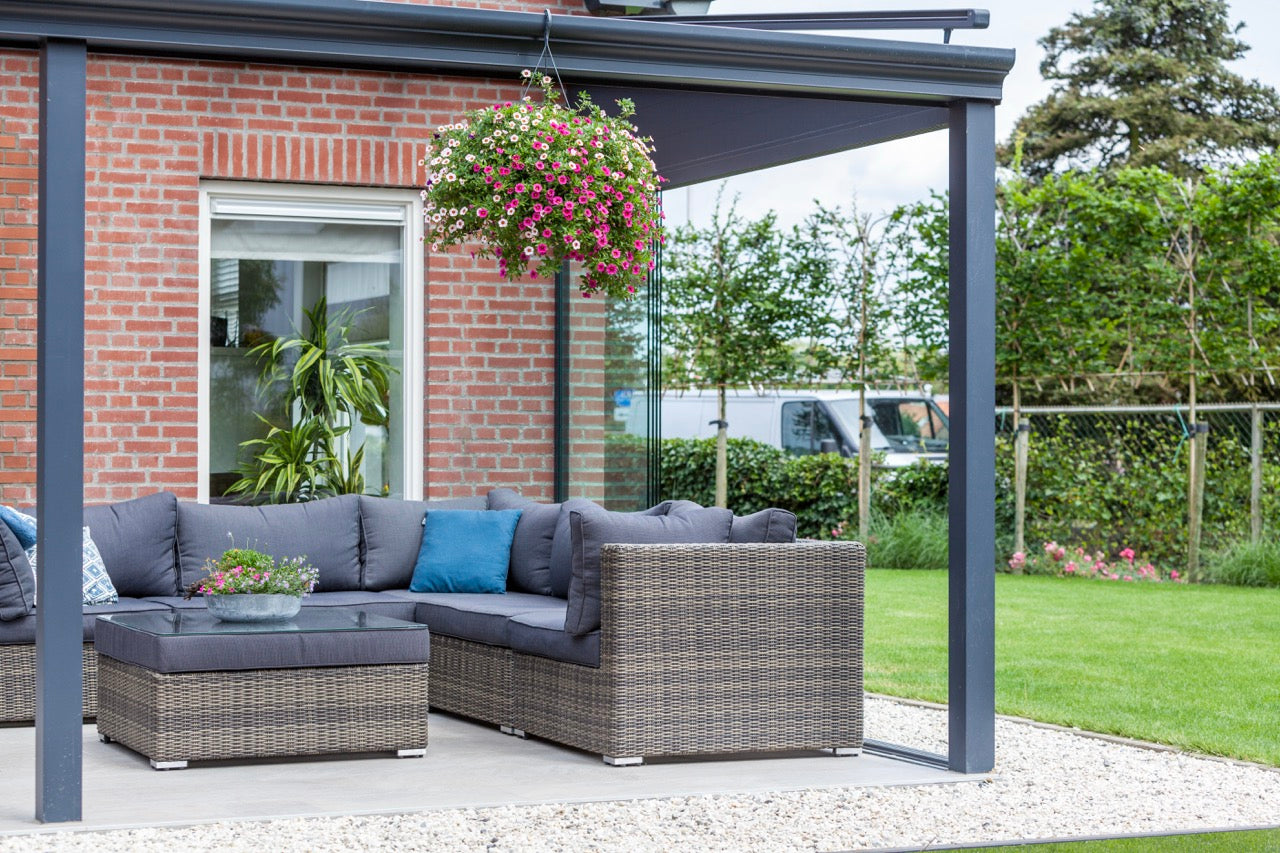 The Nobile veranda in anthracite with garden furniture and outdoor rug below